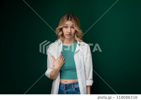 Woman Standing in Front of Green Wall Woman Standing in Front of Green Wall 118086316