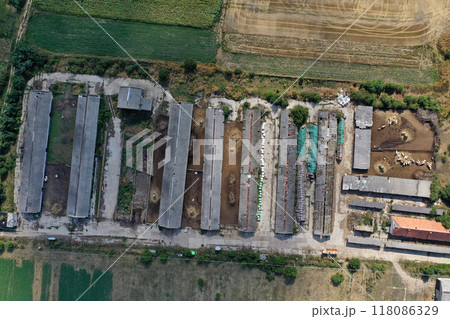 Bio farm, countryside cowshed, hangars, dairy cows, bio agricultural fields aerial Bio farm, countryside cowshed, hangars, dairy cows, bio agricultural fields aerial 118086329