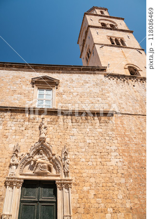 Church and bell tower of the Franciscan friary situated at the Stradun, the main street of Old town Dubrovnik in Croatia 118086469