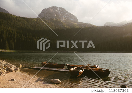 View of the Black Lake or Crno jezero , northern Montenegro. Tourist boats near wooden pier on Black lake in Durmitor national park near Zabljak, Europe View of the Black Lake or Crno jezero , northern Montenegro. Tourist boats near wooden pier on Black lake in Durmitor national park near Zabljak, Europe 118087361