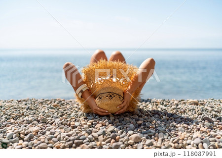 Beach Relaxation woman lies on a pebble beach. The concept of travel, vacation at sea Beach Relaxation woman lies on a pebble beach. The concept of travel, vacation at sea 118087991