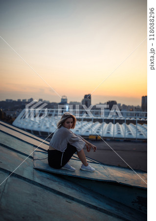 Young woman in roof enjoying sunset, freedom city atmosphere. People, lifestyle, relaxation concept. Young woman in roof enjoying sunset, freedom city atmosphere. People, lifestyle, relaxation concept. 118088296