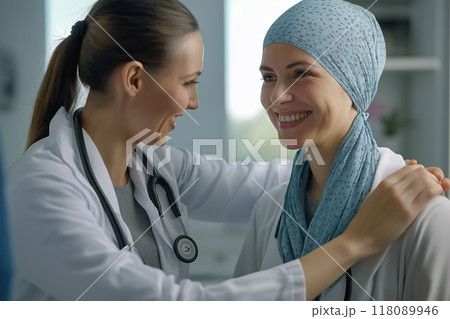 Female doctor comforting smiling woman with headscarf in hospital 118089946