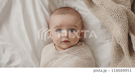Adorable baby lying on back and looking up wrapped in blanket 118089951