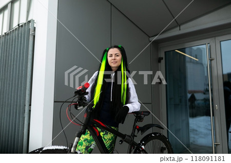 Woman With Green Hair Standing Next to Bike Woman With Green Hair Standing Next to Bike 118091181