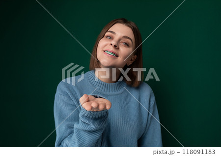 Woman in Blue Sweater Points at Something 118091183