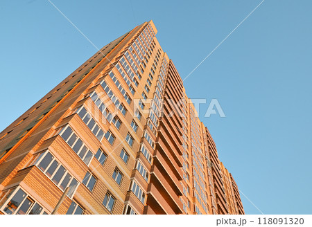 multi-storey new yellow brick house against the blue sky. Mortgage, real estate, new housing, copy space. 118091320