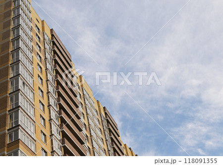 multi-storey new yellow brick house against the blue sky. Mortgage, real estate, new housing, copy space. multi-storey new yellow brick house against the blue sky. Mortgage, real estate, new housing, copy space. 118091355