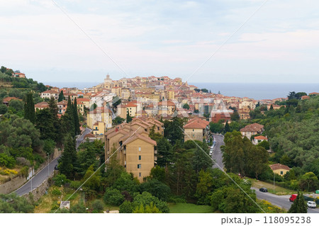 A Coastal Italian Town Nestled Amongst Green Hills on a Cloudy Day 118095238