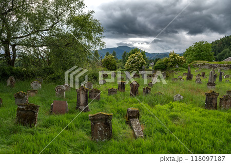 Old Graveyard With Decayed Tombstones In The Village Callander In Scotland, UK Old Graveyard With Decayed Tombstones In The Village Callander In Scotland, UK 118097187