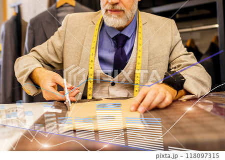 A man is cutting fabric with a pair of scissors A man is cutting fabric with a pair of scissors 118097315