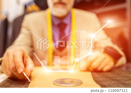 A man is sitting at a desk with a graph on a piece of paper A man is sitting at a desk with a graph on a piece of paper 118097321