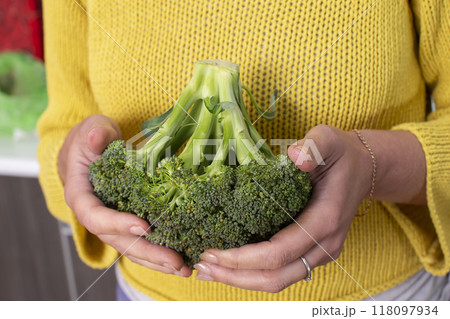 Hands holding cabbage tossed. Healthy green vegetables. 118097934