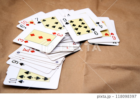 A deck of poker cards spread out on a table. 118098397