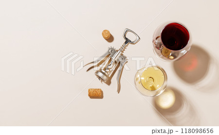 Two wine glasses alongside a corkscrew and several corks Two wine glasses alongside a corkscrew and several corks 118098656
