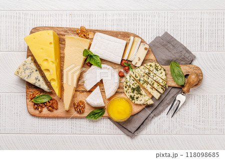 An assortment of various cheeses arranged on a board, highlighting different textures 118098685