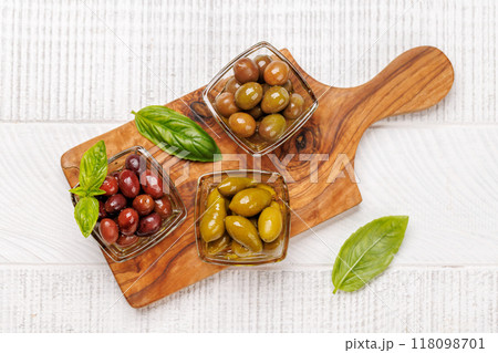 An assortment of various olives presented in a bowl, showcasing different colors, textures, and flavors An assortment of various olives presented in a bowl, showcasing different colors, textures, and flavors 118098701