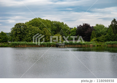 Forest and green meadows at the water pond outside of Aachen, Germany 118098938