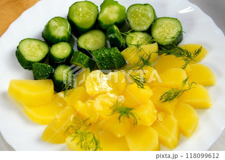 Prepared served dish with boiled potatoes, butter, pickles decorated fresh dill. 118099612
