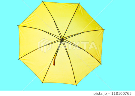 Open yellow umbrella on turquoise background 118100763