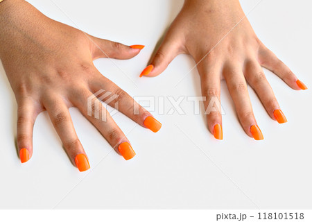 Girl's hands with orange false nails. woman manicure Girl's hands with orange false nails. woman manicure 118101518