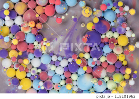 Colorful abstract arrangement of floating paint droplets on a surface creating vibrant patterns in a creative art setting 118101962