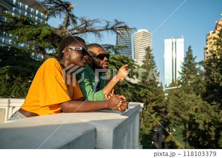 Interested contented african american couple tourists resting in trip enjoy panoramic view of city. 118103379