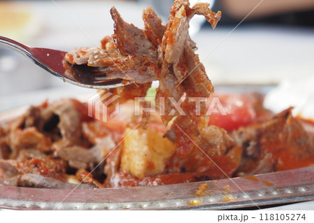 A Savory and Flavorful Plate Featuring Tender Meat Accompanied by Fresh Vegetables and Sauce A Savory and Flavorful Plate Featuring Tender Meat Accompanied by Fresh Vegetables and Sauce 118105274