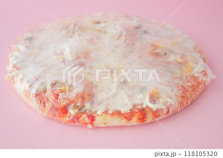 Delicious Frozen Pizza Featuring Cheese and Various Toppings, All Wrapped Securely in Plastic Delicious Frozen Pizza Featuring Cheese and Various Toppings, All Wrapped Securely in Plastic 118105320
