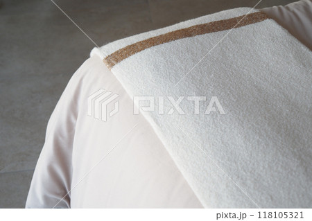 A Soft White Towel Placed on a Light Surface, Evoking Calmness and Elegance in Bathing Spaces A Soft White Towel Placed on a Light Surface, Evoking Calmness and Elegance in Bathing Spaces 118105321