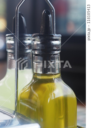 CloseUp of Olive Oil and Vinegar Dispensers in Natural Lighting, Perfect for Cooking and Seasoning CloseUp of Olive Oil and Vinegar Dispensers in Natural Lighting, Perfect for Cooking and Seasoning 118105413