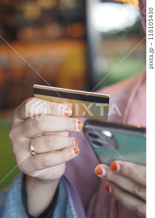 women hand holding credit card and using smart phone shopping online  118105430