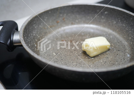A Piece of Butter Melting Delightfully in a NonStick Frying Pan at the Cooking Station 118105516