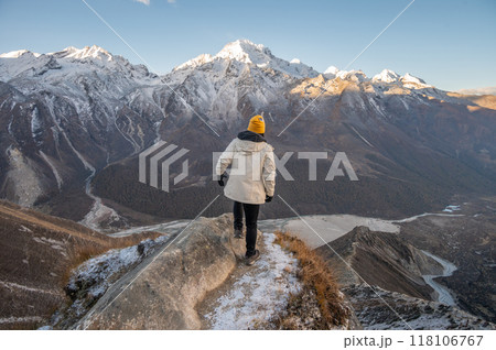 Rear view of female tourist while climbing on Tsergo Ri (4,990m) the high point on the Langtang valley trek of Nepal. 118106767