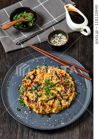 Japanese pancake with cabbage on a plate, top view 118110640