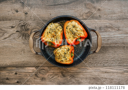 Top view of baking casserole with roasted goat cheese stuffed bell peppers 118111178