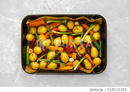 Overhead view of baking tray with fresh vegetables and spices 118111183
