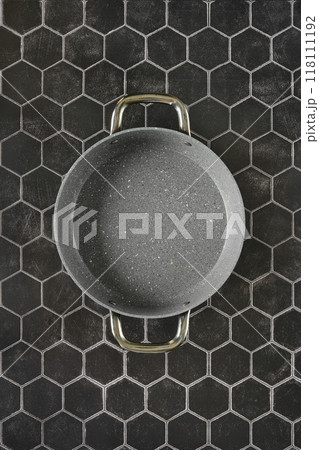 Top view of double handled frying pan on hexagon tile background Top view of double handled frying pan on hexagon tile background 118111192