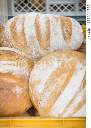 Traditional loaves of wheat or rye bread in bakery Traditional loaves of wheat or rye bread in bakery 118111758