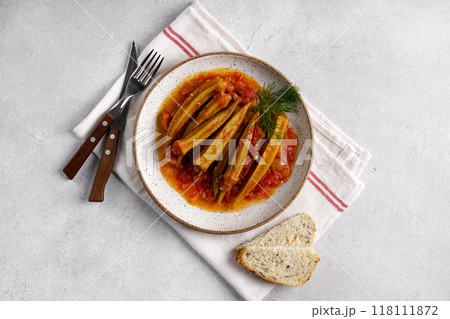Okra dish with tomato sauce on gray background, top view, copy space Okra dish with tomato sauce on gray background, top view, copy space 118111872