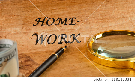 Word HOMEWORK on papyrus in a composition with a fountain pen, a magnifying glass and American dollars 118112331