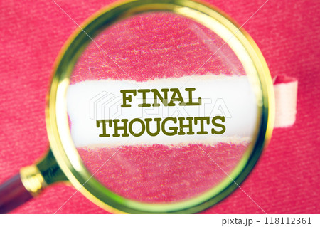 FINAL THOUGHTS Final Thoughts text on white paper through a magnifying glass under a torn piece of red paper 118112361