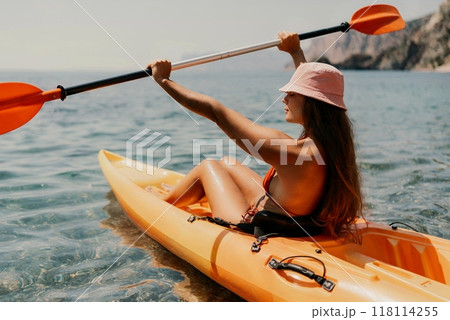 Kayak sea woman. Happy attractive woman with long hair in red swimsuit, swimming on kayak. Summer holiday vacation and travel concept. 118114255