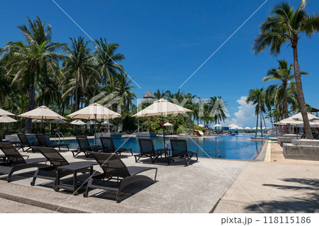 Bedchair at resort pool by sea against blue sky in summer, Hua Hin 118115186