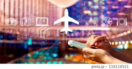 Flight ticket booking concept with person using a smartphone in city at night 118118521