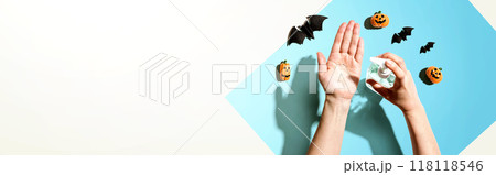 Applying sanitizer gel with Halloween theme 118118546