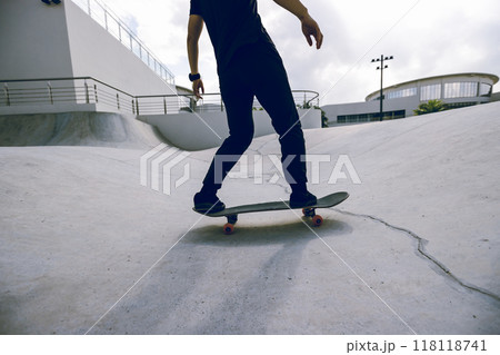 Skateboarder skateboarding at skatepark in city 118118741
