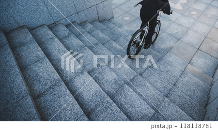 Woman free rider riding bike going down city stairs Woman free rider riding bike going down city stairs 118118781