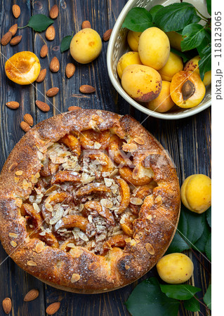 Open pie (galette) with apricots and almonds. Open pie (galette) with apricots and almonds. 118123065