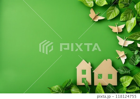 Symbols representing sustainable living are artistically arranged against a bright green background, showcasing a blend of nature and eco-friendly design aimed at promoting environmental awareness. 118124755